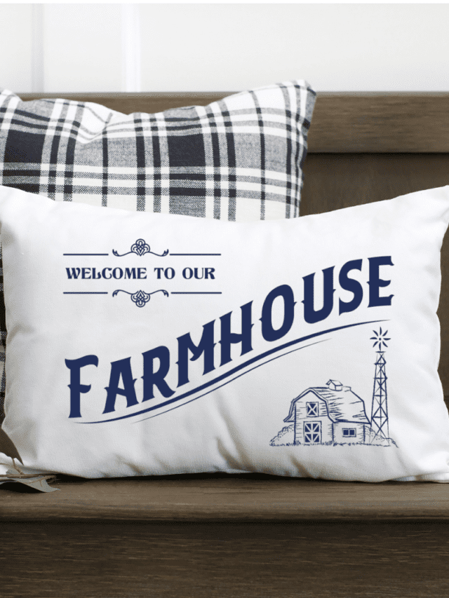 Welcome to our farmhouse free SVG cut file shown on a while pillow with dark blue vinyl.