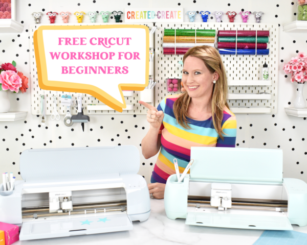 Abbi Kirsten with a Cricut Maker 3 and Explore 3 machine in a bright colorful craft room. Abbi is pointing to a sign that says, Free Cricut Workshop for Beginners.