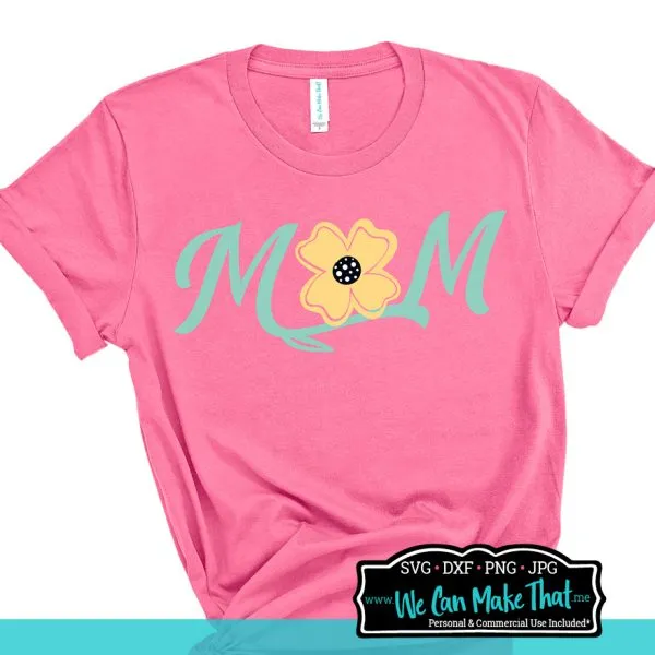 Pink t-shirt with text Mom in teal and a yellow flower center.