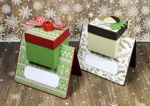 Free Cricut file of two place cards with attached small gift boxes in Christmas decor.