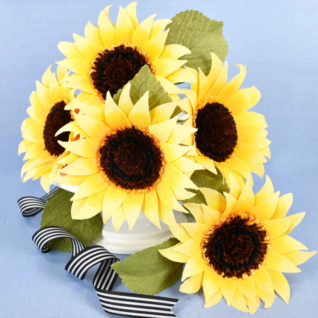crepe paper sunflowers with a blue background