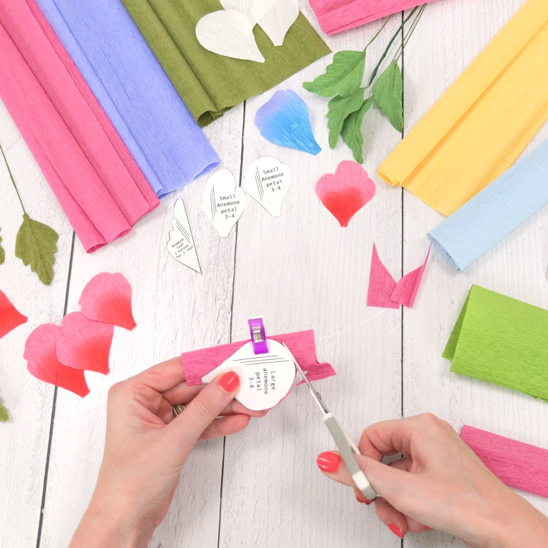 Cutting crepe paper flowers by hand