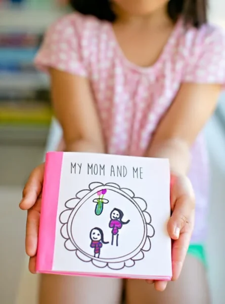 Girl holding a Mother's Day book with text My Mom and Me