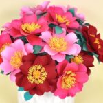 bouquet of pink and red wild roses in a white vase