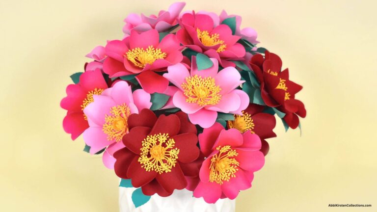bouquet of pink and red wild roses in a white vase