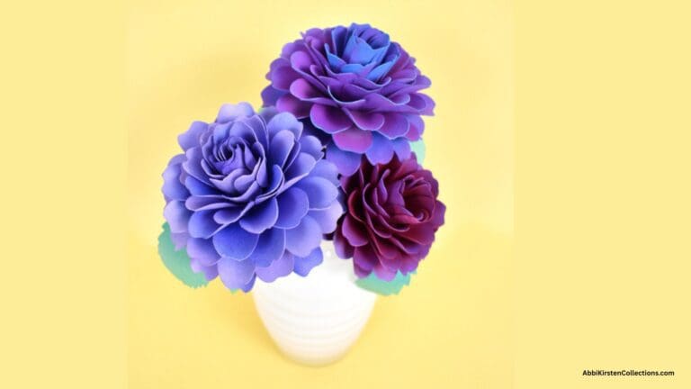 purple and red dahlia paper flowers in white vase
