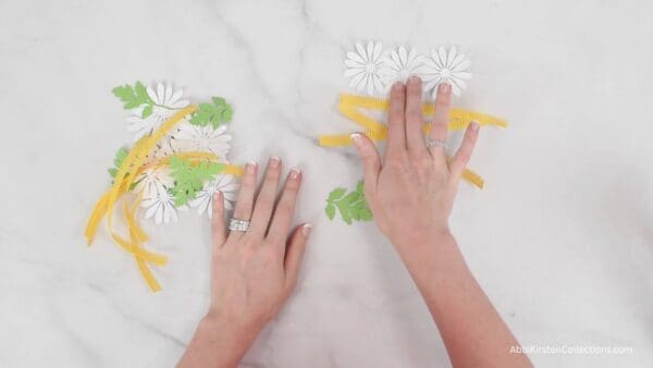 white daisy petals and  yellow center strips with greenery