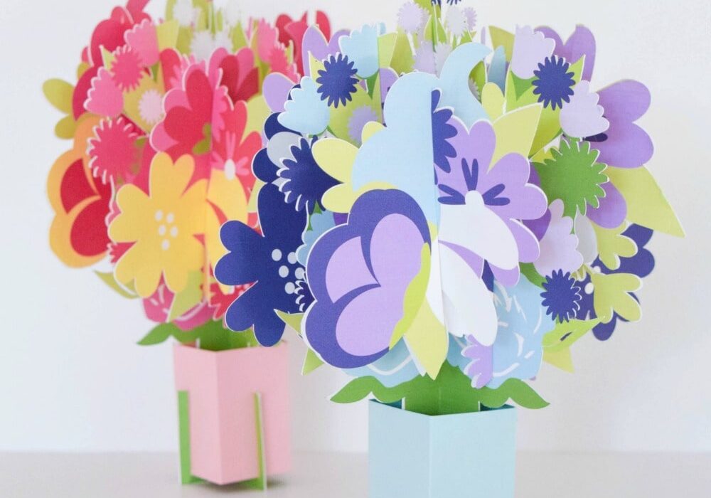 The image shows two pop up flower bouquet cards in pink and purple perfect for a Mother's Day gift. Download the templates for free on Abbi Kirsten Collections.